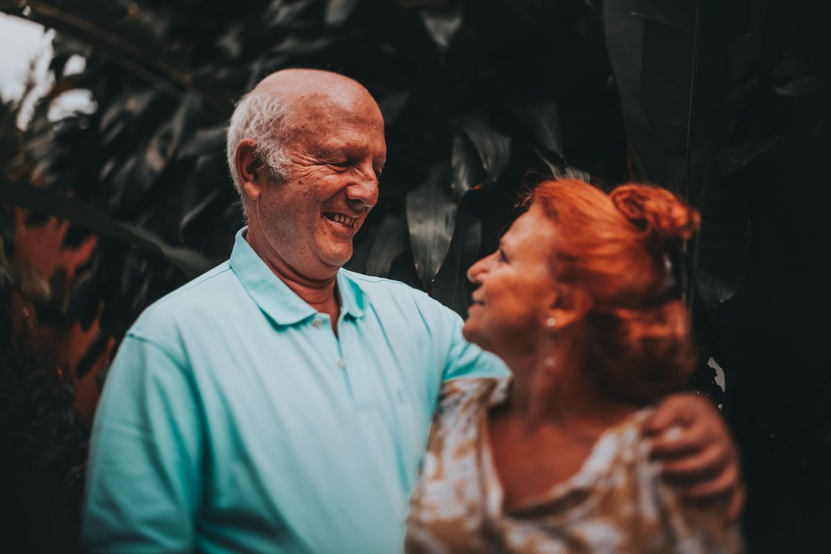 An older couple smiling at each other